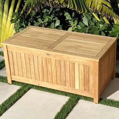 a large wooden box sitting on top of grass