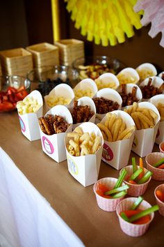 there are many small cups that have food in them on the table with other items