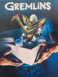 the dvd cover for we're here, featuring an image of a creature holding a paper boat