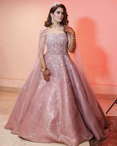 a woman in a pink gown and tiara