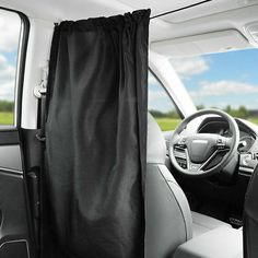 the interior of a car with a black curtain hanging from it's center console