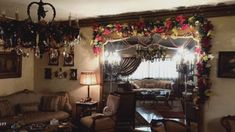 a living room filled with furniture and christmas decorations on the wall above it's windows