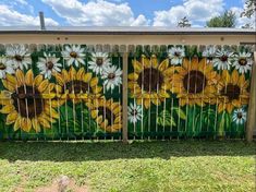 a fence with sunflowers painted on it