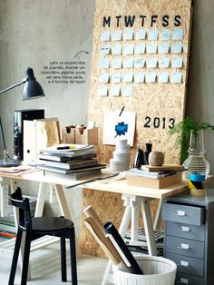 a desk with several items on it in front of a bulletin board that says mtwtfiss 2013