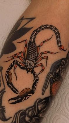 a man's arm with a scorpion tattoo on it