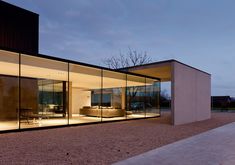 a modern house with glass walls on the outside