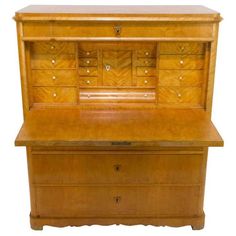 an old fashioned wooden desk with drawers