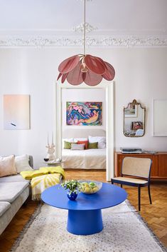 a living room filled with furniture and a blue table