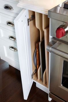 an open drawer in the middle of a kitchen