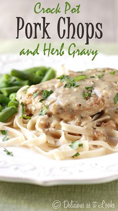 a white plate topped with pasta covered in gravy and green beans next to broccoli