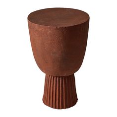 a large brown vase sitting on top of a table