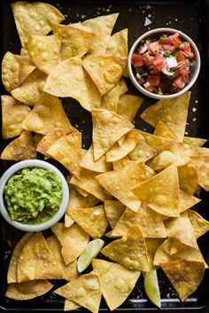 tortilla chips with guacamole, salsa and apple slices on a tray