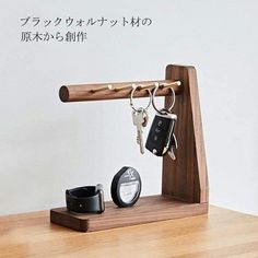 a wooden stand holding two keys and some other items