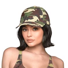 a woman wearing a camo hat and bra with her hair in the middle of her face