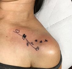 a woman's chest with birds and hearts tattoo on her left side breast area