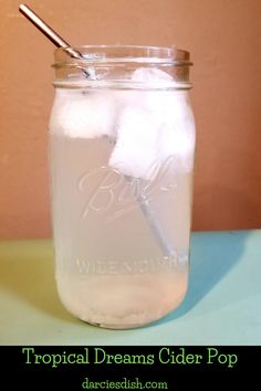 a glass jar filled with ice and two cotton swabs on top of it