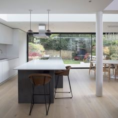 an open kitchen and dining room area with large sliding glass doors to the back yard