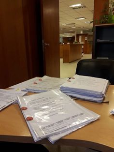 many papers are on the table in an office