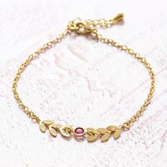 A lovely gold plated chain bracelet with leaf vine and Swarovski crystal birthstone detail.Two gold vines reach around to hold a sparkling Swarovski crystal in place. Choose from 12 shades of stone to create the focal centrepiece of this gorgeous bracelet, pick your favourite colour or simply match your birthstone using our guide. A wonderful personalised gift for her for any occasion.This item is lovingly handmade to order just for you in the JOY studio.Presented in an organza gift bag with the Birthstone Charm Necklace, Family Bracelets, Swarovski Crystal Bracelet, Birthstone Bracelet, Favourite Colour, Birthstone Bracelets, Bar Bracelets, Charm Bangle, Gorgeous Bracelet