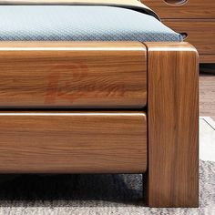 a close up of a bed with a wooden headboard and foot board on carpeted floor