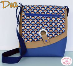 a blue and brown purse with an animal print on it