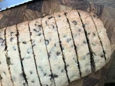 a loaf of chocolate chip bread sitting on top of a cutting board next to a knife