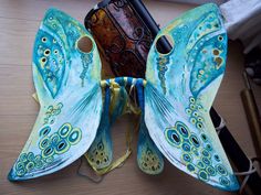 a butterfly shaped object sitting on top of a wooden table