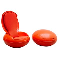 an orange chair and ottoman sitting next to each other on a white background with the lid open