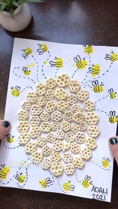 someone is holding up a card with bees and honeycombs in the shape of circles