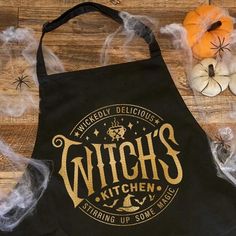 a witches kitchen apron sitting on top of a wooden floor