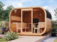 a wooden hot tub sitting on top of a lush green field