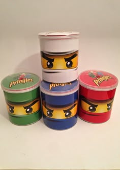 four plastic containers with lego faces on them