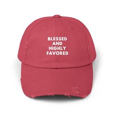 a red baseball cap with the words, blessed and highly flavored printed on it