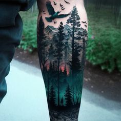 a man's leg with trees and birds on it