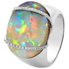 "La Gioconda" opal ring showcases an eye-catching opal (14.52ct) from our own mines in Jundah-Opalville. Inspired by the Mona Lisa’s enigmatic smile, this piece features two intricate lines of brilliant-cut diamonds embracing a light boulder opal. Set in 18K white gold, this ring is a discreet yet powerful fashion statement. Designed by Renata Bernard. The gemstone at the centre of this opal ring is an Australian boulder opal from Opal Minded's own opal mines in Jundah-Opalville in Queensland. P Opal Resin, Vintage Opal Engagement Ring, Water Opal, Jelly Opal, Ammolite Jewelry, Peruvian Blue Opal, Genie Bottle, The Mona Lisa, Honey Yellow