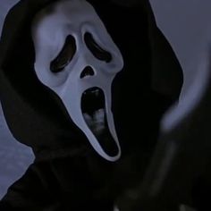 a person wearing a ghost mask with their mouth open