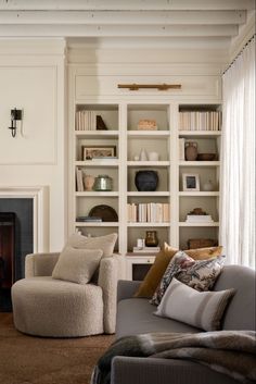 a living room filled with furniture and a fire place