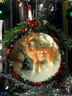 a christmas ornament hanging from the side of a tree with ornaments around it