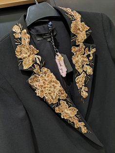 Handmade decorated Blazer.. The decorated part of the jacket is the collar and the edge of the pockets.     The asymmetric decorated ornaments are flowers made of gold sequins of different sizes which in a middle with 3-4 crystal stones of 6 mm and  gold lined crystals, tubular shape of 10mm, in combination with the black color of the jacket, form together a unique contrast, similar to a shiny necklace around the neck...    Jacket size: 8 (S)    Brand: next TAILORING    With a rich imagination, Elegant Blazer With Gold Embroidery For Party, Elegant Party Blazer With Gold Embroidery, Elegant Gold Embroidered Blazer, Gold Embellished Outerwear For Formal Occasions, Elegant Gold Embroidered Outerwear, Elegant Gold Sequined Blazer, Elegant Gold Sequin Blazer, Luxury Embellished Blazer For Festive Occasions, Festive Embellished Gold Outerwear