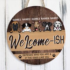 a wooden sign that says welcome - ish with four dogs on it and the words,