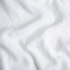 an image of white linen textured with natural dyes for bedding or decorating