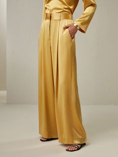 Looking for a bottom that is both stylish and comfy? Well, this pair of ankle-length palazzos in lemon drop is a perfect pick. Crafted from high-quality watershine silk, these pants offer a comfortable and loose fit. The glossy finish of the fabric adds a touch of elegance and sophistication to your overall look. Be it your casual outing or a light festive look, it will go for each occasion. Pair these pants with our matching ensemble, and create a head-turning outfit that exudes confidence and allure. Luxury Silk Straight Pants Palazzo Set, Luxury Silk Wide Leg Pants For Women, Luxury Silk Pants With Tapered Leg, Luxury Raw Silk Palazzo Set For Formal Occasion, Luxury Silk Palazzo Set For Festive Season, Luxury Silk Pants For Festivals, Luxury Silk Palazzo Set For Party, Luxury Multicolor Pants With Elastic Waistband, Luxury Yellow Art Silk Palazzo Set