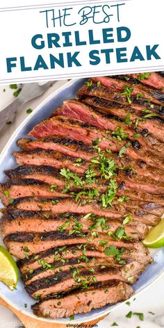 the best grilled flank steak on a plate with lime wedges and parsley