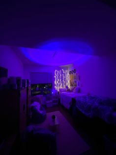 a room with two beds and purple lights