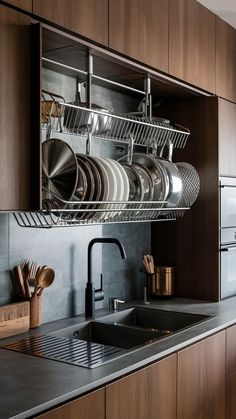 a kitchen with wooden cabinets and stainless steel dish drying racks on the wall above the sink