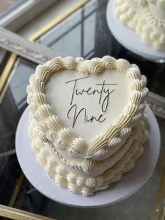 there is a heart shaped cake with the words twenty nine written on it in cursive writing