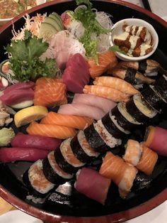 a platter filled with different types of sushi