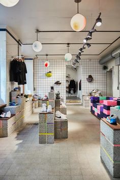 a room filled with lots of different types of shoes and clothing hanging from the ceiling