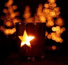 a lit candle with a star on it