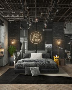 an industrial style bedroom with black and white decor, wood flooring and exposed lighting